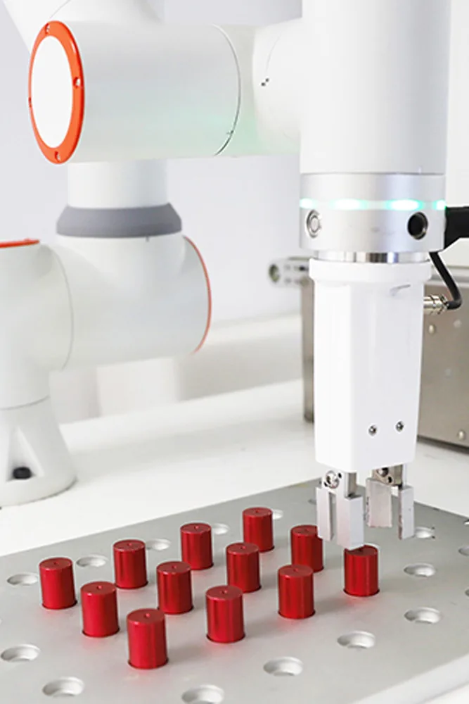Cobot gripper picking parts from a fixture plate